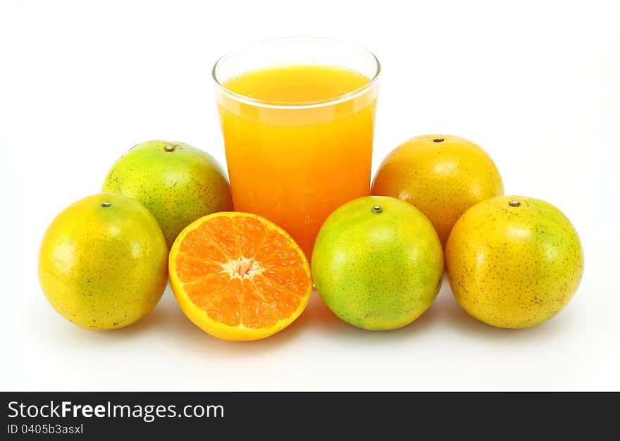 Tangerines and juice glass on white background