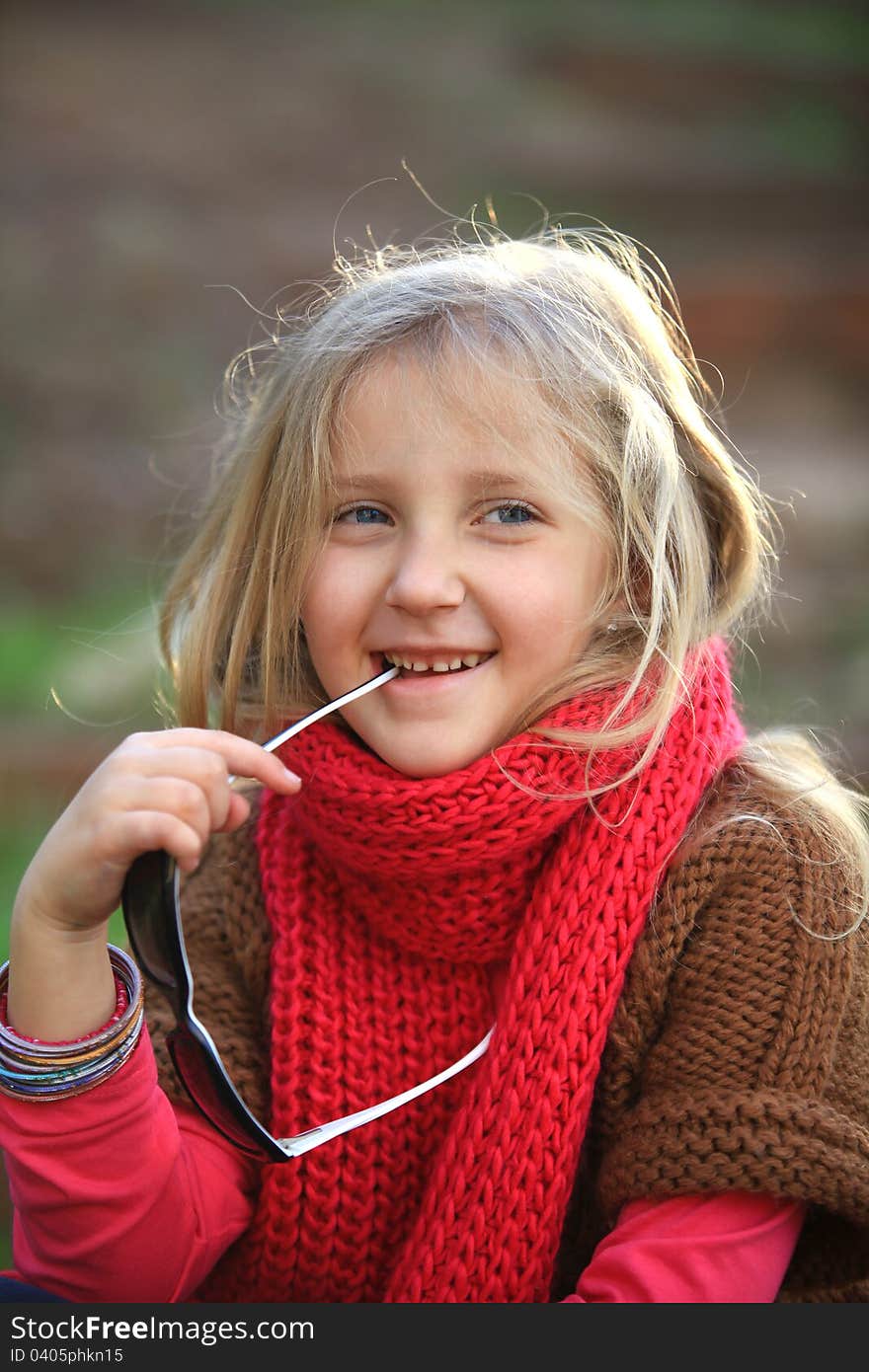 Portrait of blond girl smiling outside autumn day. Portrait of blond girl smiling outside autumn day