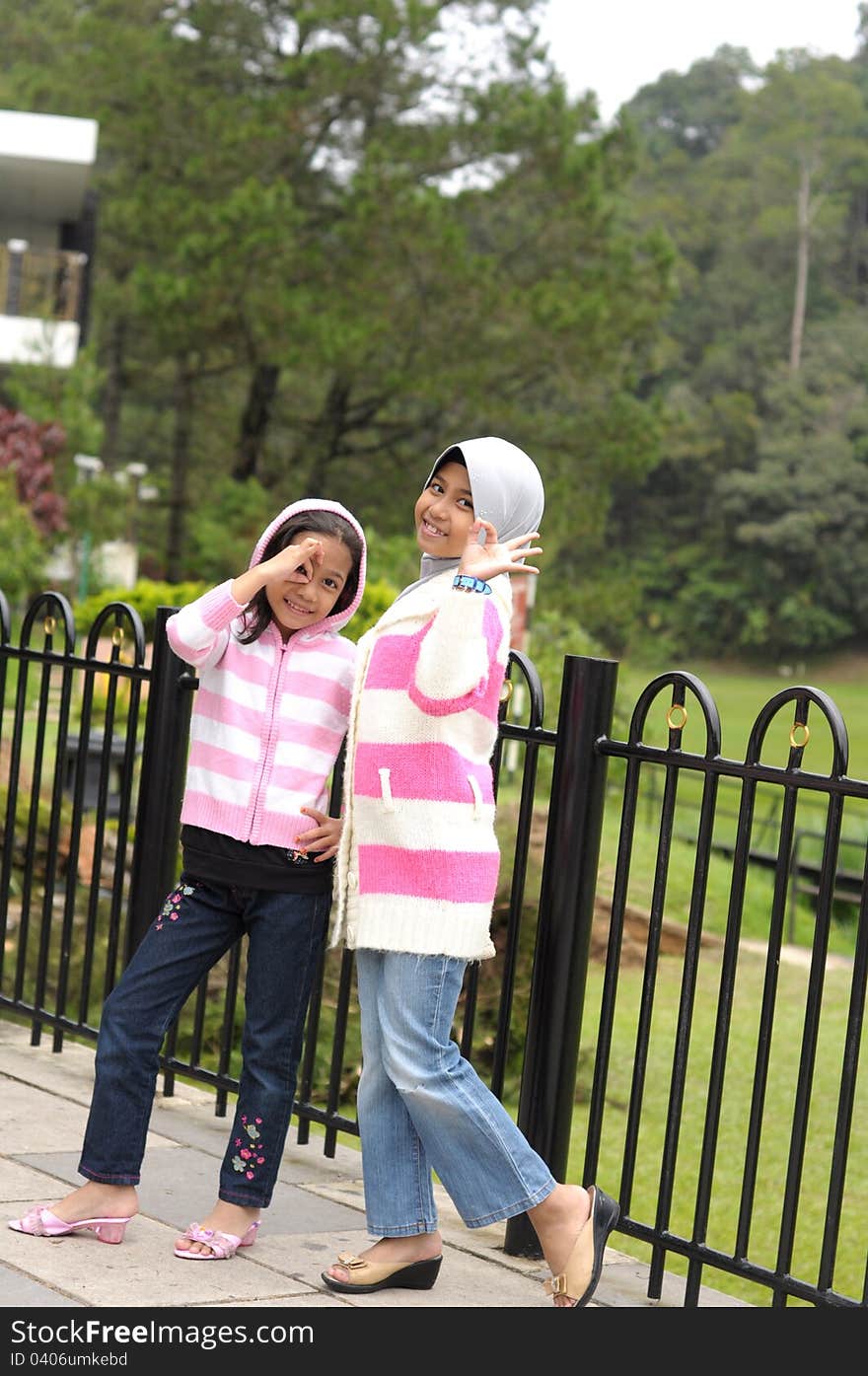 Two young girls having fun at highland park, outdoor portrait. Two young girls having fun at highland park, outdoor portrait.