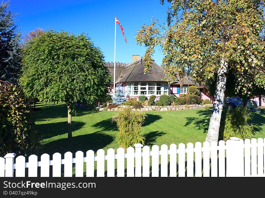 Traditional Danish summerhouse with flag flying high