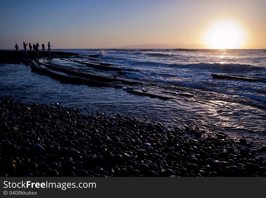 Group Of People Standing At The Ocean Shoreline