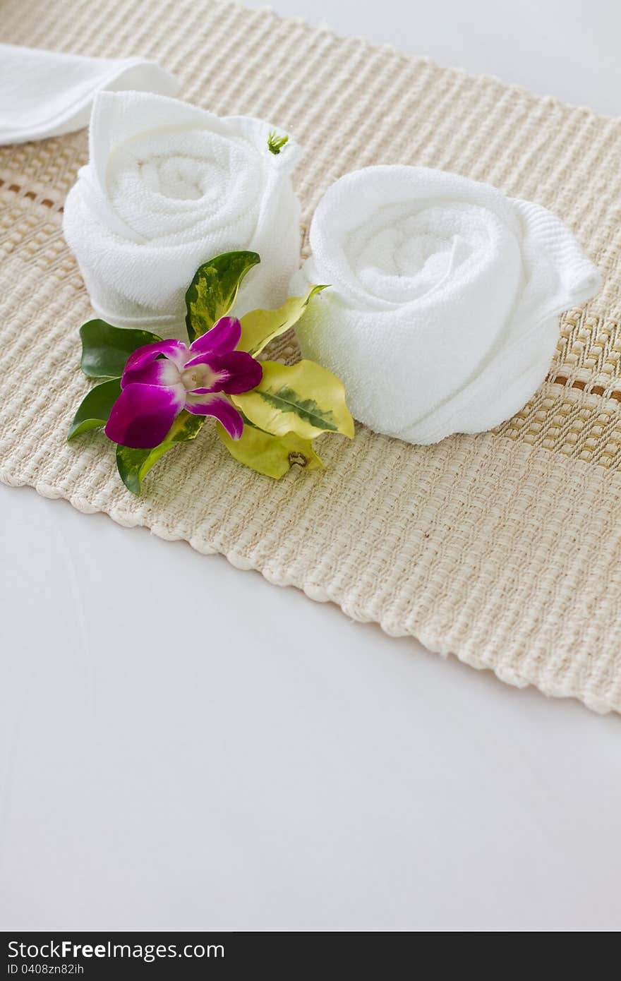 Decorative towel and flower on the bed. Decorative towel and flower on the bed