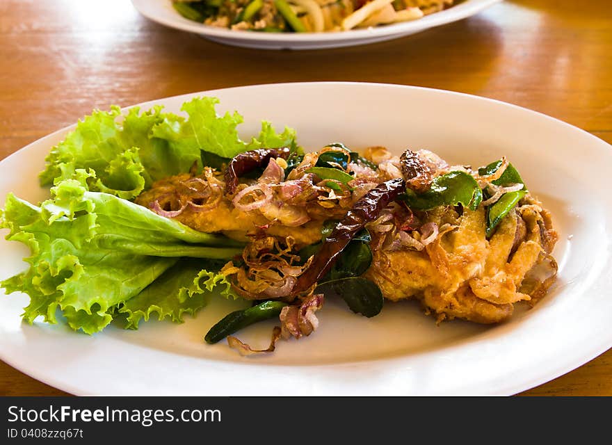 Fried fish with fresh herbs and spicy