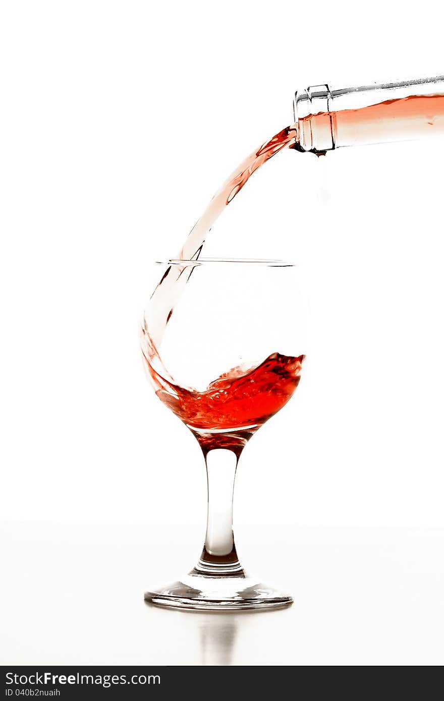 Pouring rose wine in glass isolated on white background. Pouring rose wine in glass isolated on white background