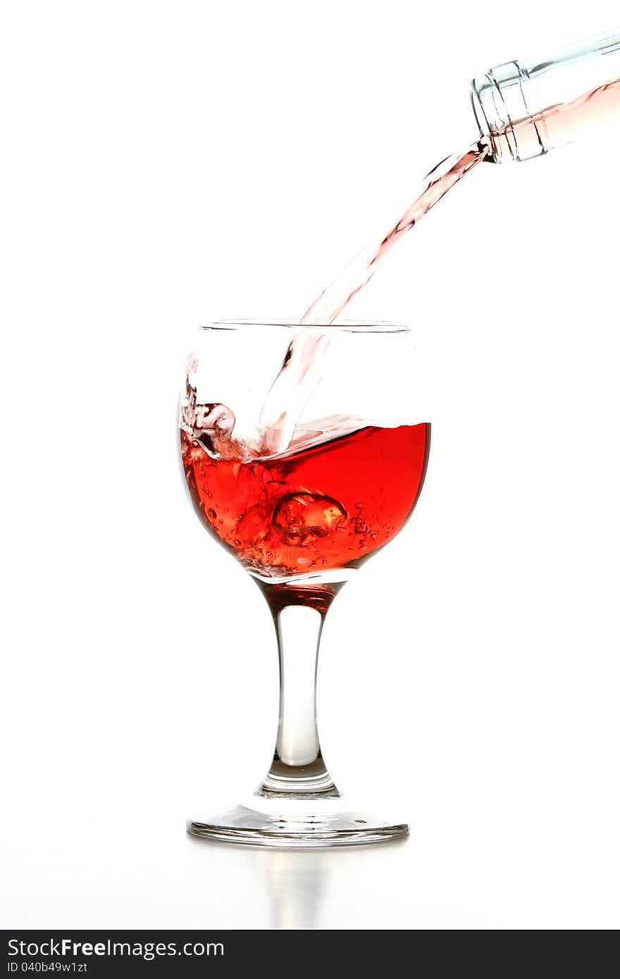 Pouring rose wine in glass isolated on white background. Pouring rose wine in glass isolated on white background