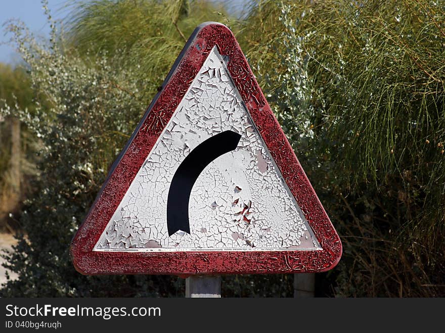 Old road sign with cracked paint