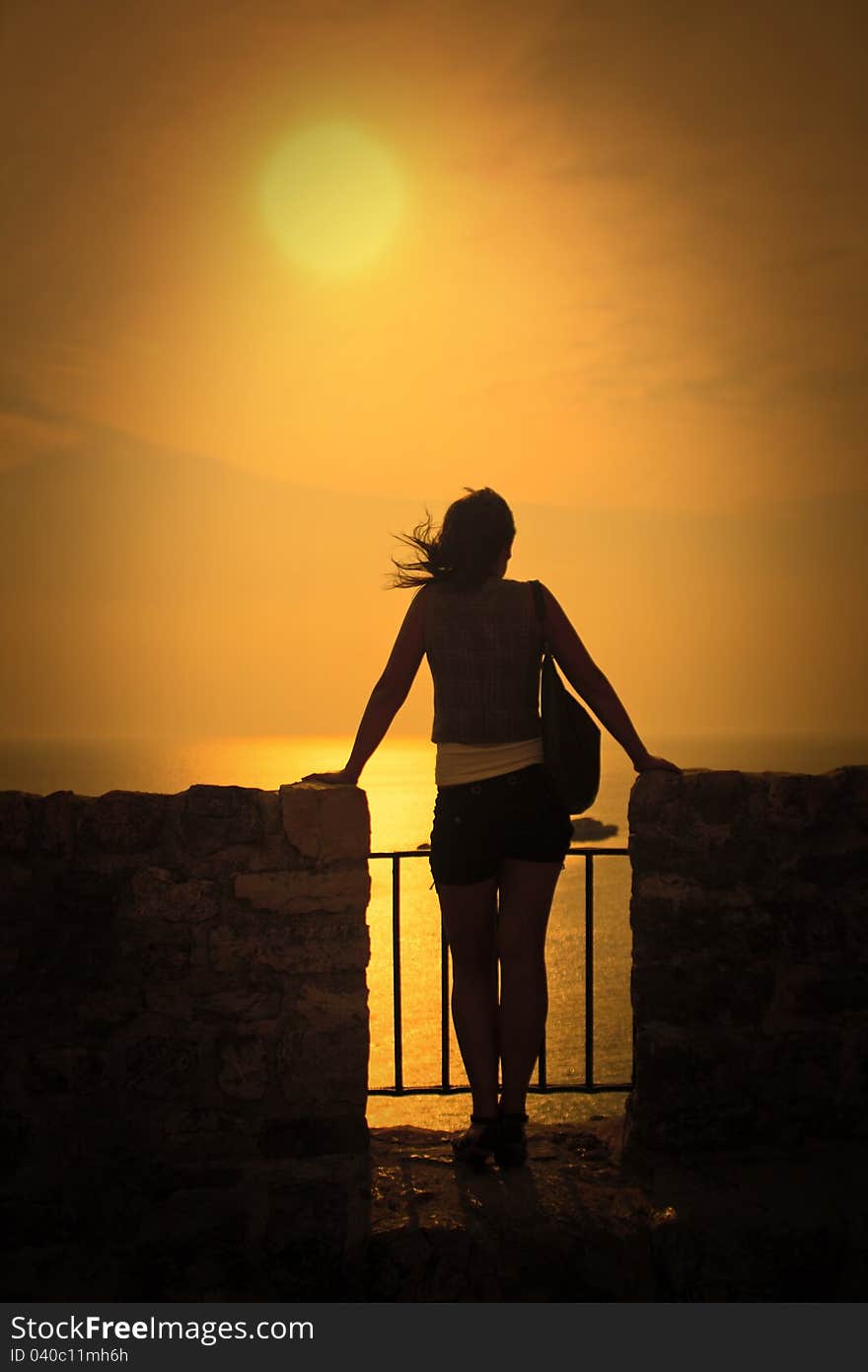 Young woman watching sundown in Montenegro