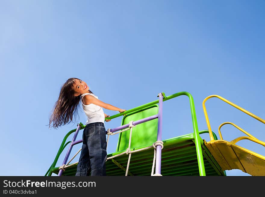 Cute little girl enjoys playing in a children, Outdoor Portrait