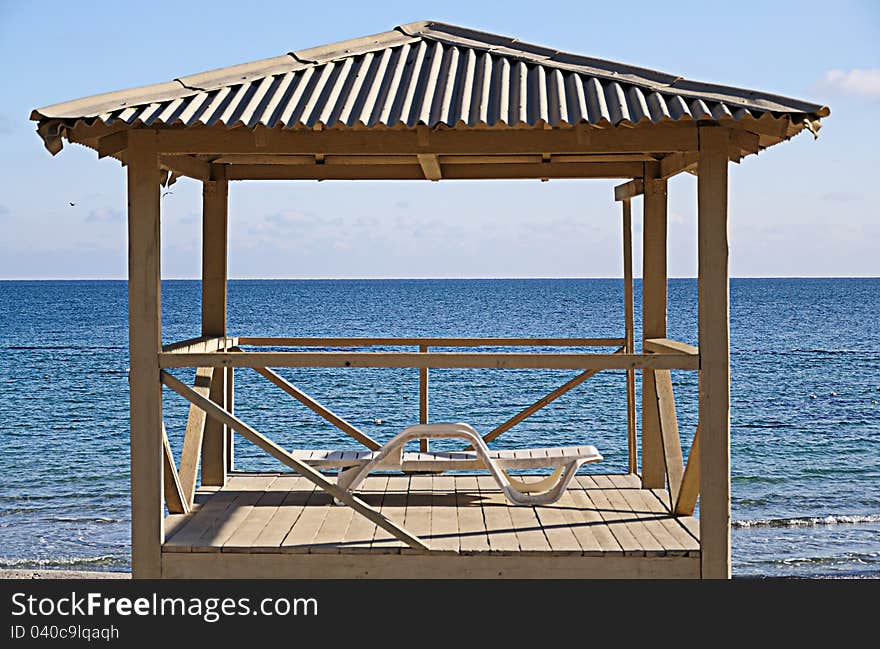 Empty tower of the rescuer in a sunny day on a background of the sea