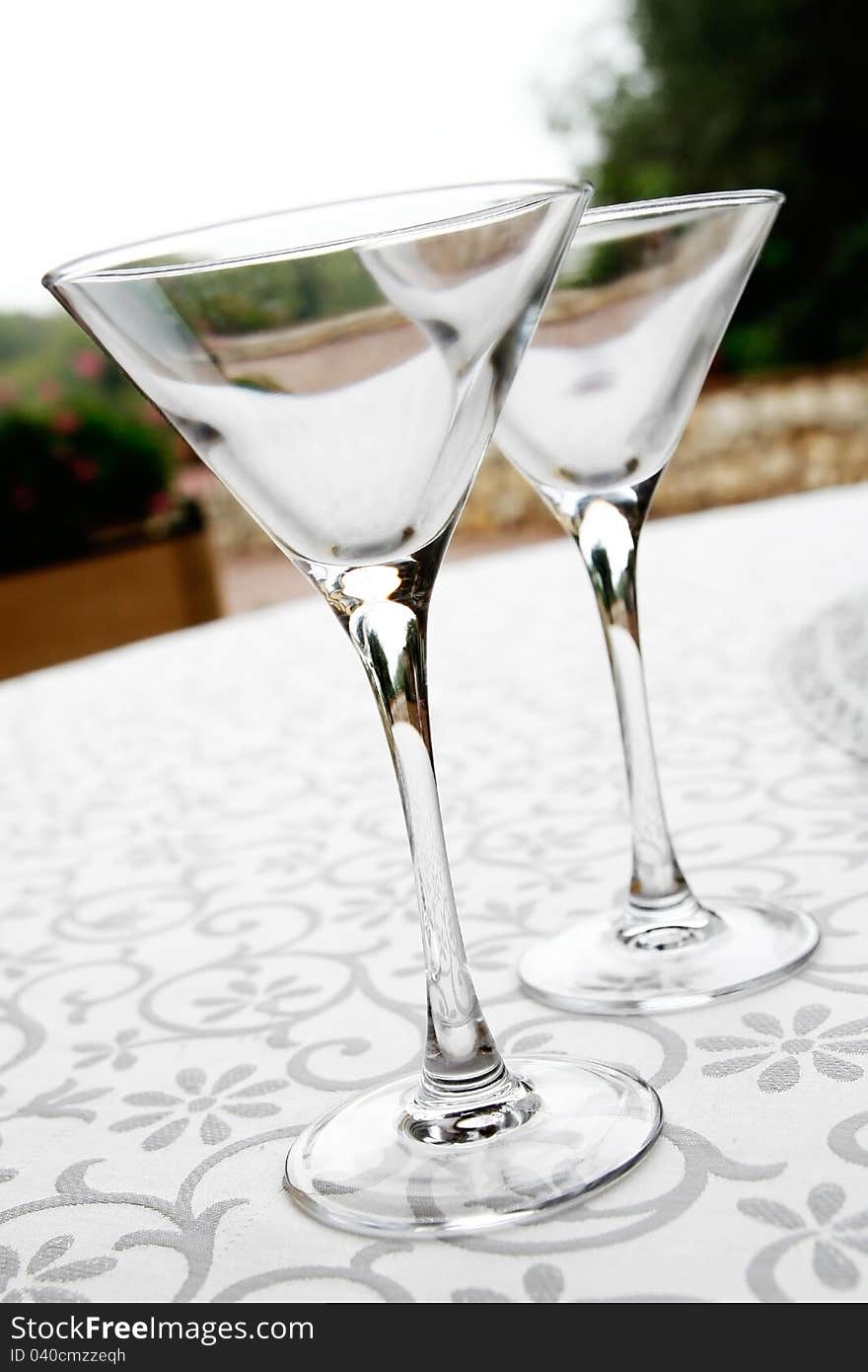 Close up of Two Martini glasses on an outside table during a wedding