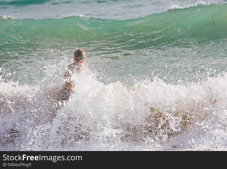 Waves crashing against a body surfer. Waves crashing against a body surfer