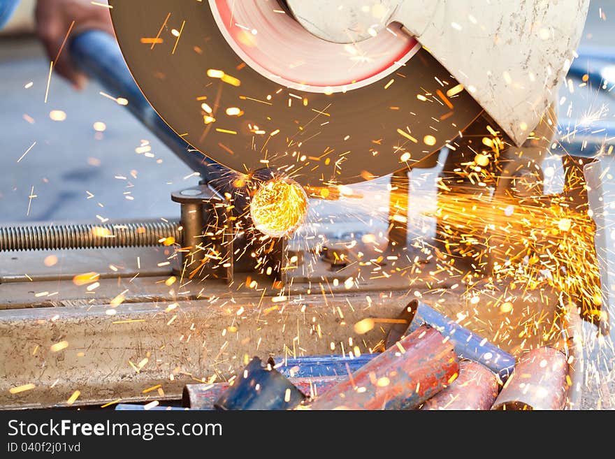 Image of The smith are cutting steel with electric saw