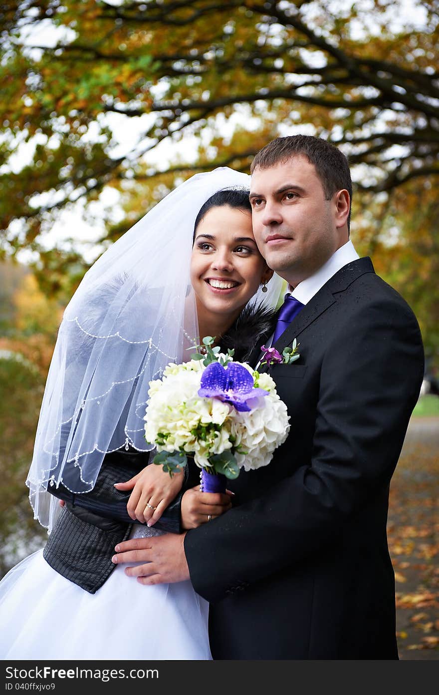 Joyful Bride And Groom In Autumn Park