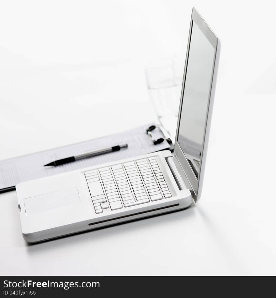 Workplace, white laptop computer on table