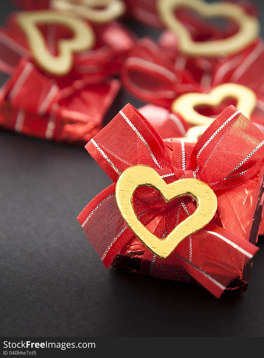 Valentines chocolate in red on dark background. Valentines chocolate in red on dark background