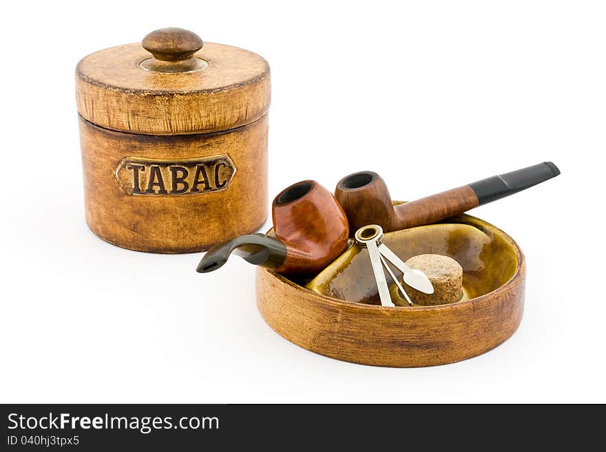 Two pipes and tobacco tin on white background. Two pipes and tobacco tin on white background