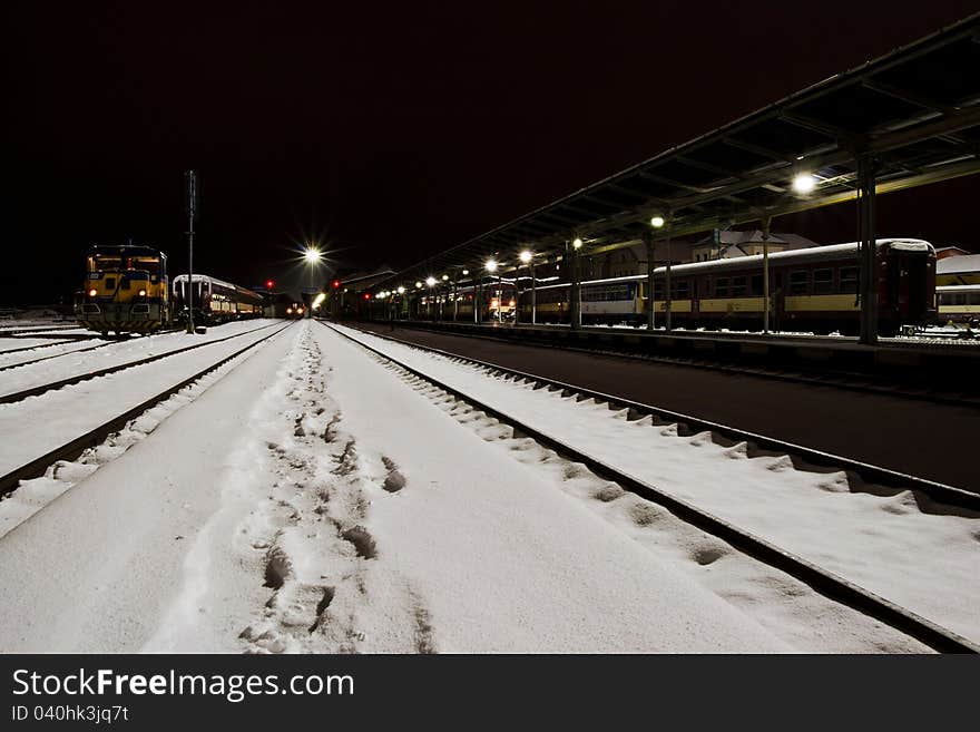 Snow in the night train station.