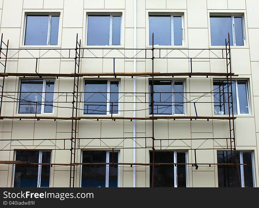 Scaffold against the wall and some windows