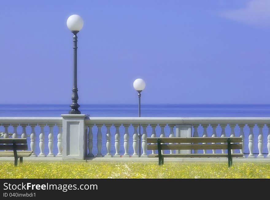 Waterfront with street lamps and seats