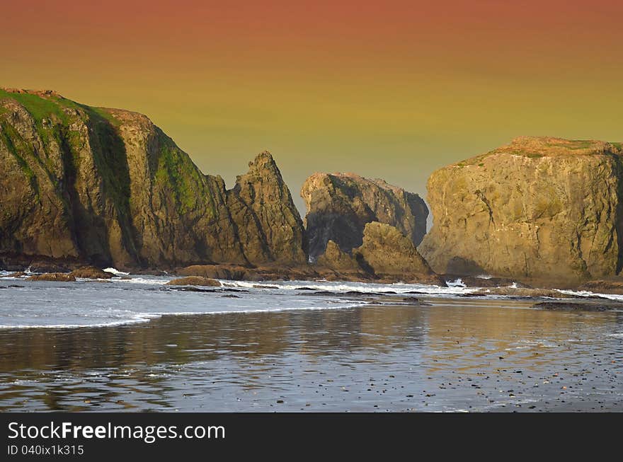 Sunset over the rocks, along the beach