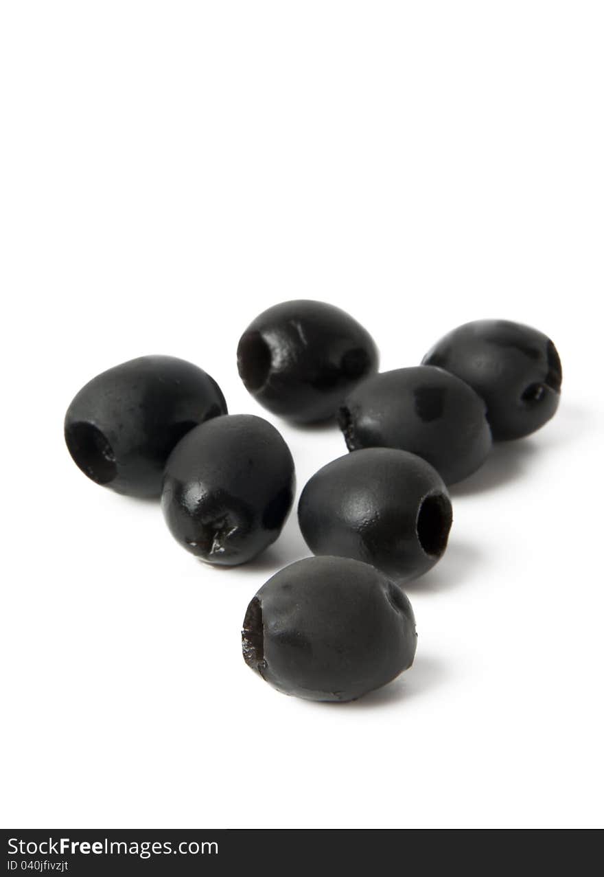 Black olives in a bowl  on white