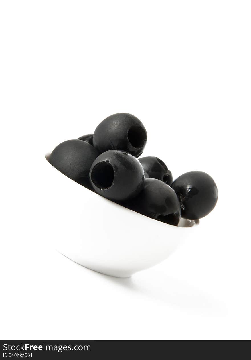 Black olives in a bowl  on white