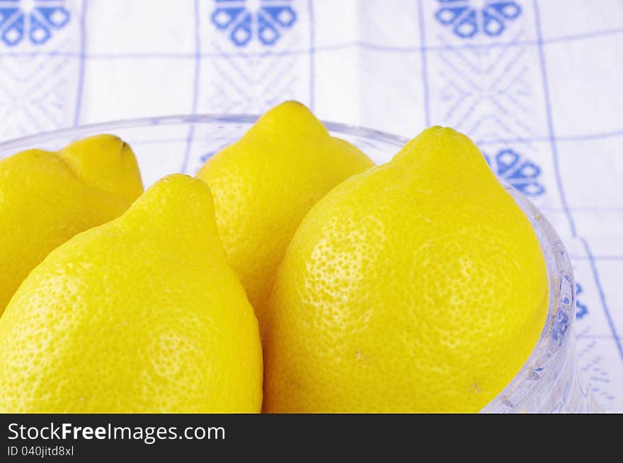 Lemon Fruits inside a glass on a blue white tablecloth, Yellow, Citrus