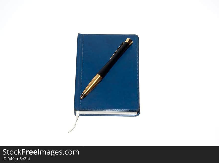 Pen on notebook, isolated on white background.