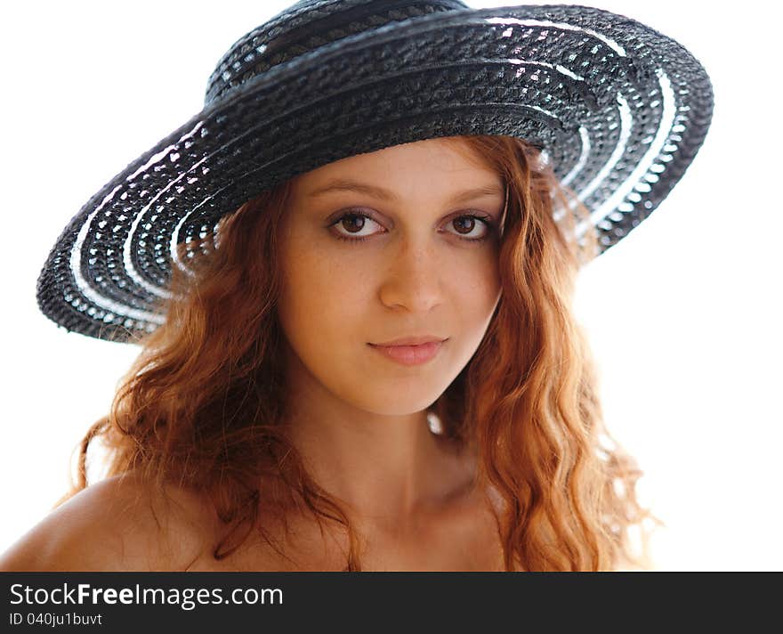 A portrait of a gorgeous young woman in a black hat. A portrait of a gorgeous young woman in a black hat