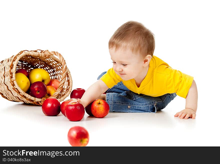 Funny child with basket filling red apples