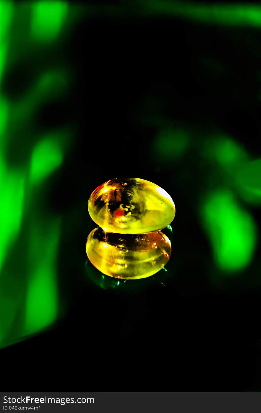 Glass stone on the mirror surface. black background