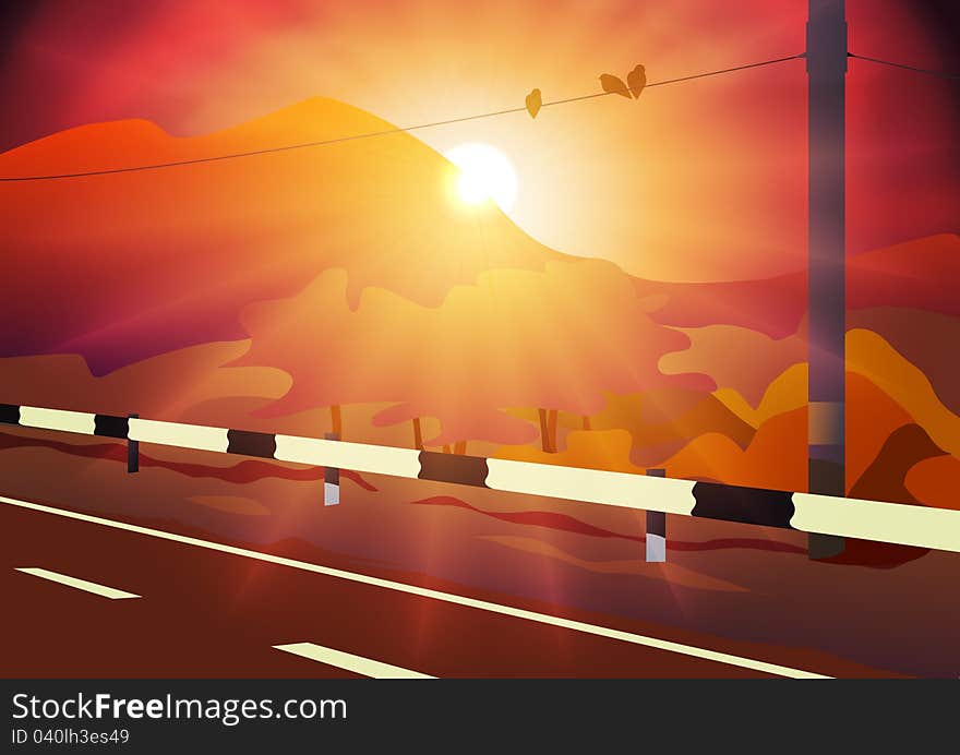 Asphalt road under sunset sky