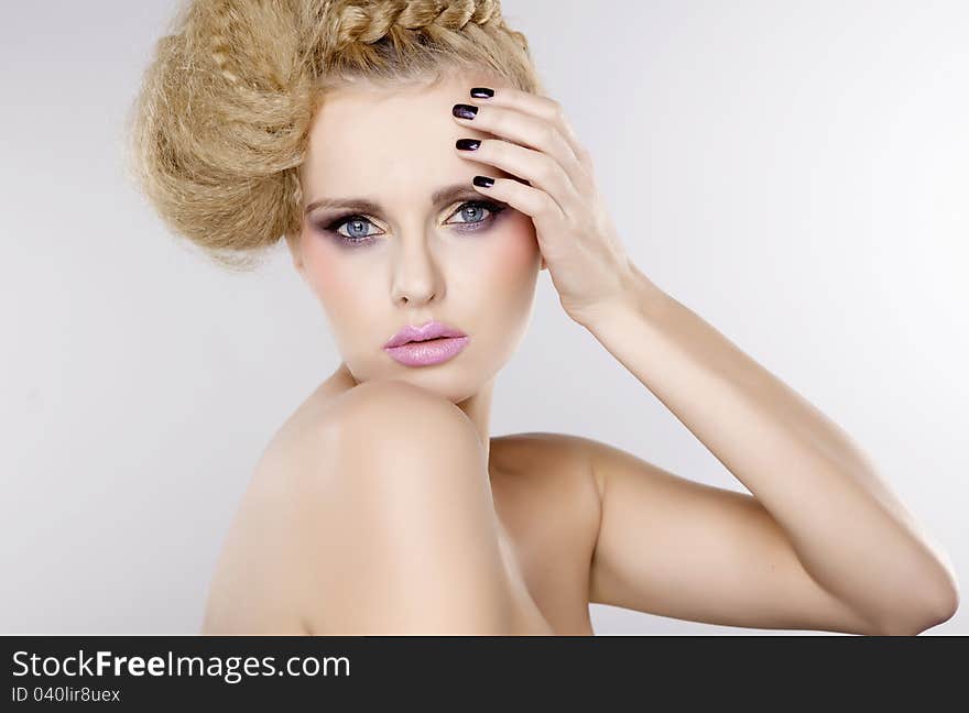 Young pretty woman with beautiful blond hairs and multicolor makeup  on white background