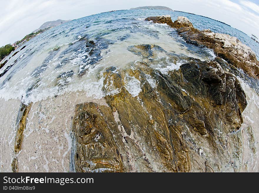 Curve of sea and wave on the rock