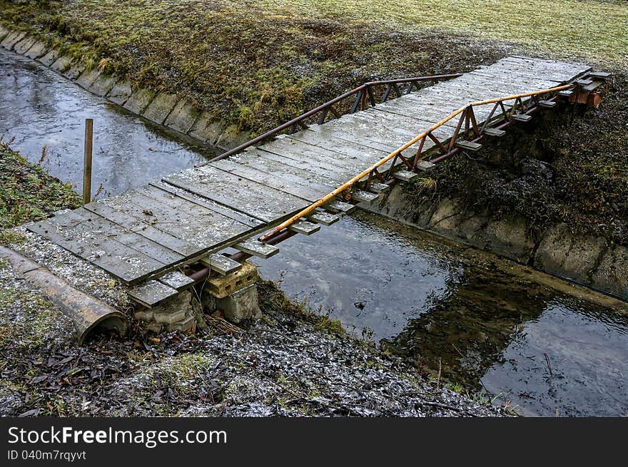 Simple Wooden Bridge Across Regulated Stream