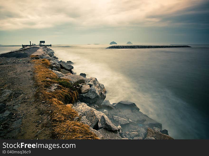 Lonely pier with dramatic cloudy while sunrise. Lonely pier with dramatic cloudy while sunrise