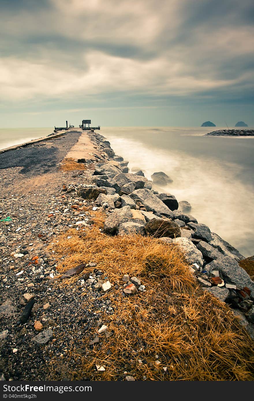 Lonely pier with dramatic cloudy while sunrise. Lonely pier with dramatic cloudy while sunrise