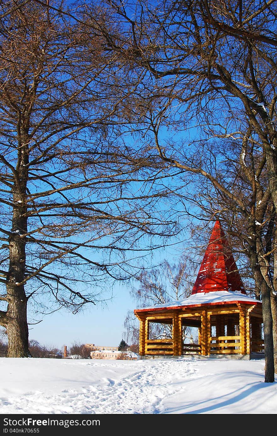 Wooden arbor in park in the winter