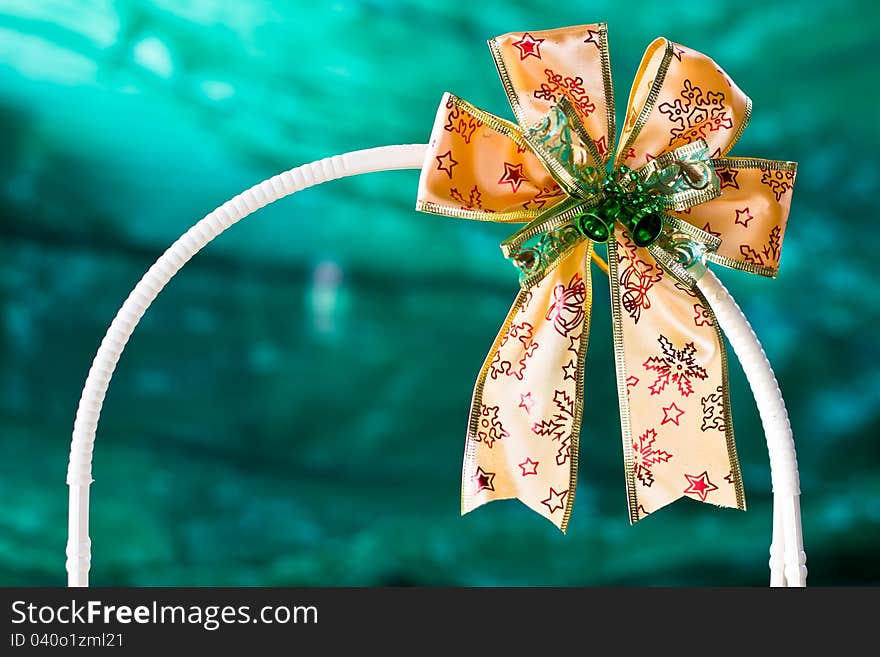 Close-up gold gift ribbon on green background. Close-up gold gift ribbon on green background