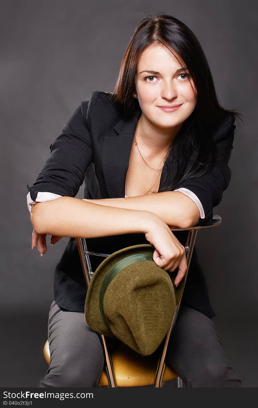 Portrait of smiling young woman sitting on chair. Portrait of smiling young woman sitting on chair