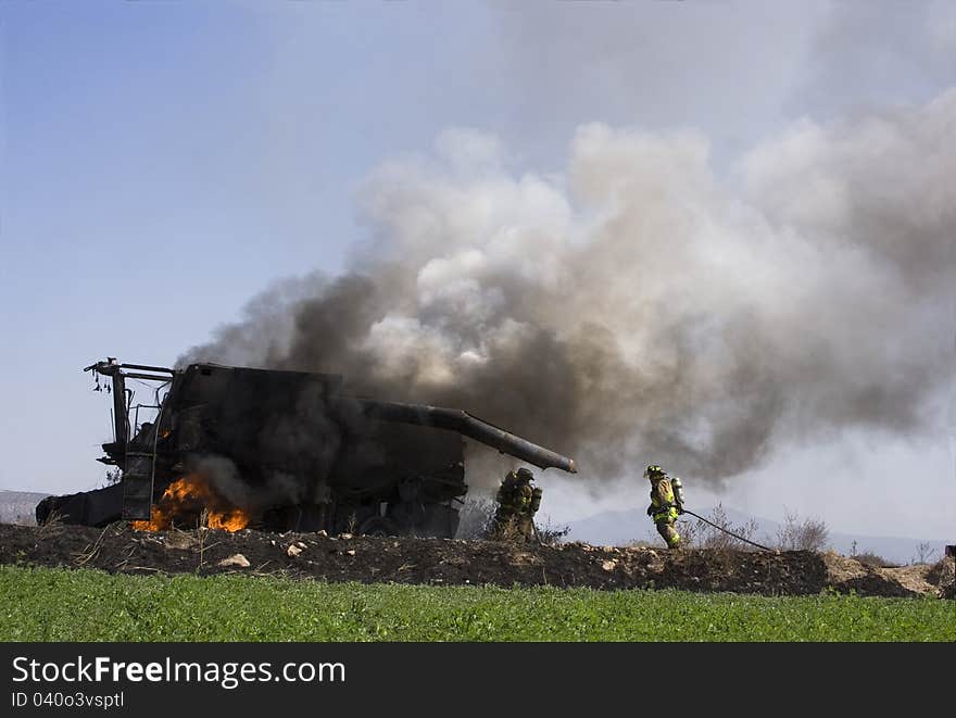 Firefighters put out burning tractor in the countryside