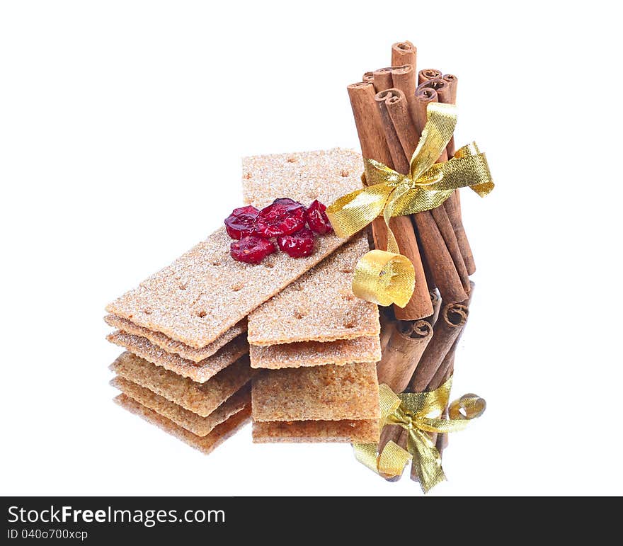 Cinnamon sticks ,stack of crispbread on white background ,reflection, blueberry red,