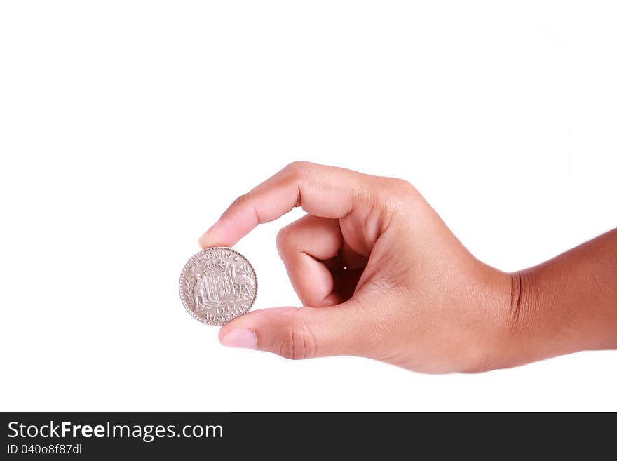 Woman hand holding silver florin on isolated white background