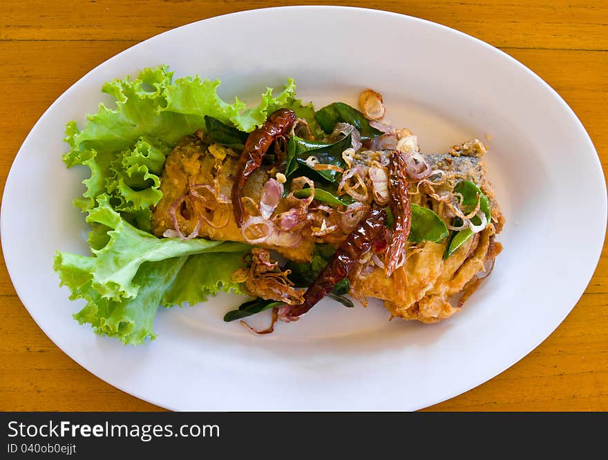 Fried fish with fresh herbs and spicy