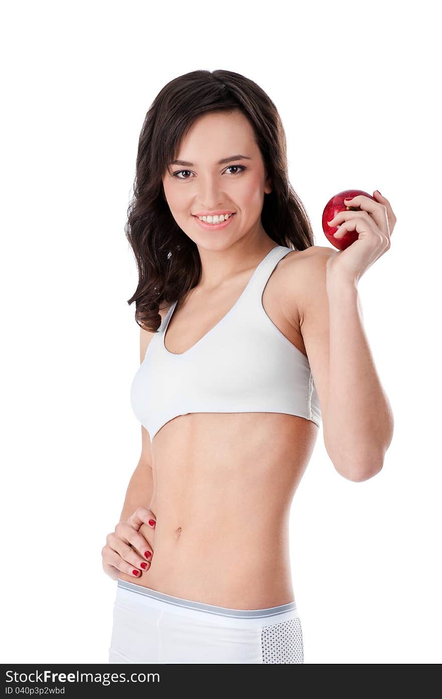 Yound fit girl holding red apple and smiling