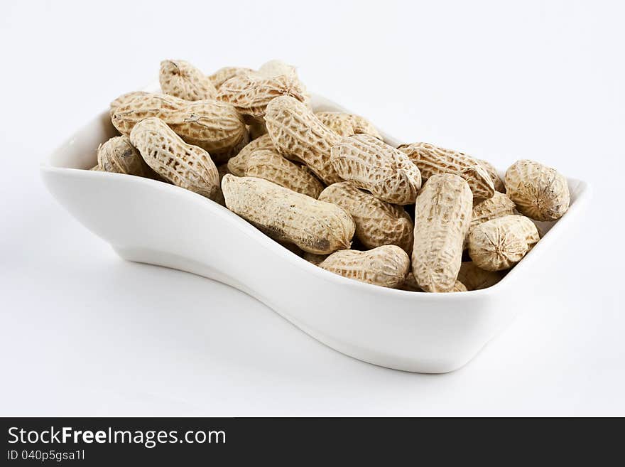 Peanut in shell snack on white plate. Peanut in shell snack on white plate