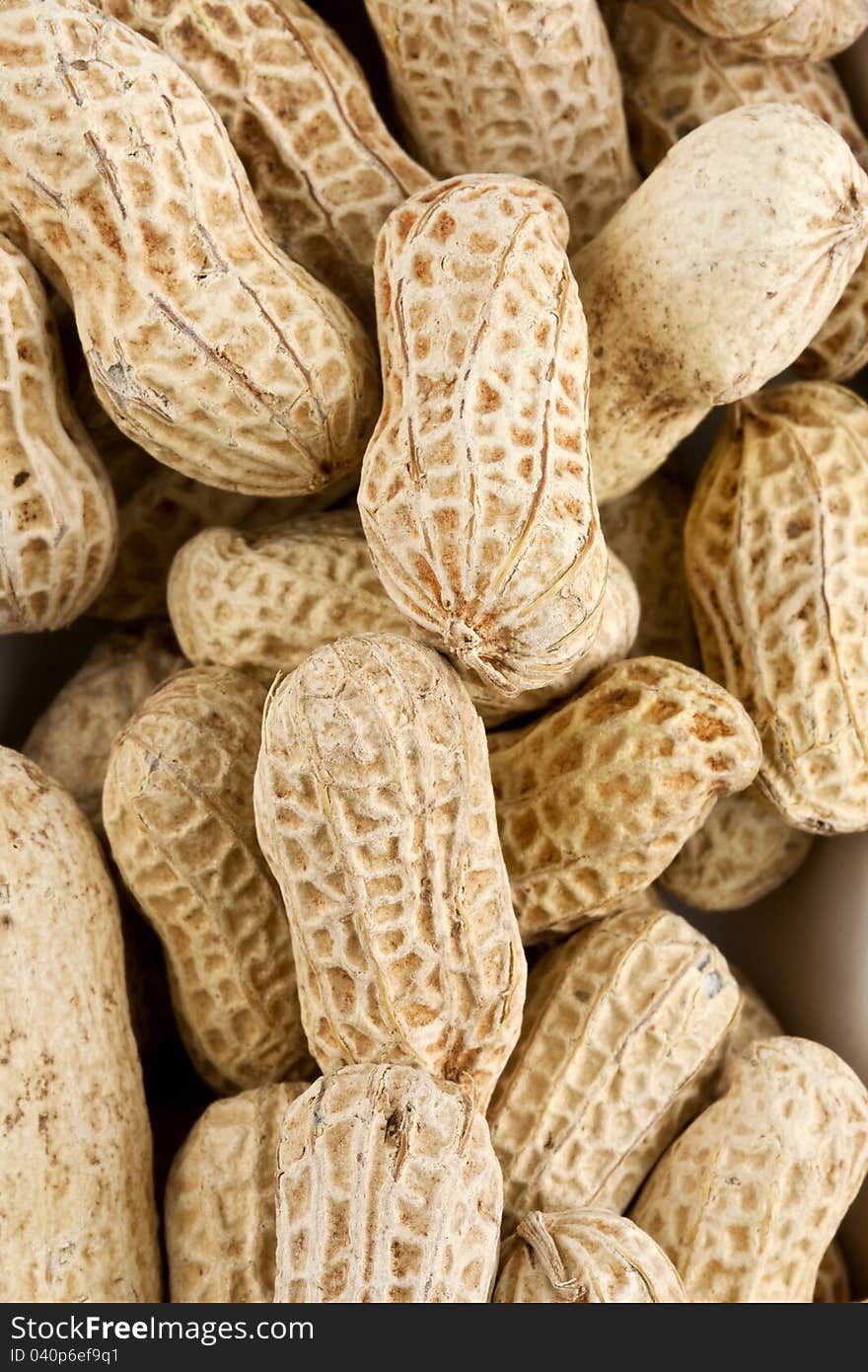 Background of roasted peanuts in shell