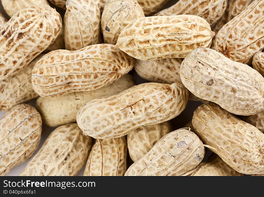 Background of roasted peanuts in shell