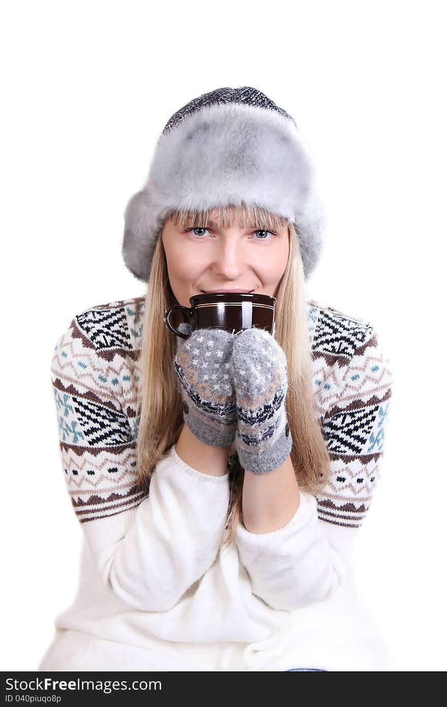 Beautifu woman in fur hat with a cup