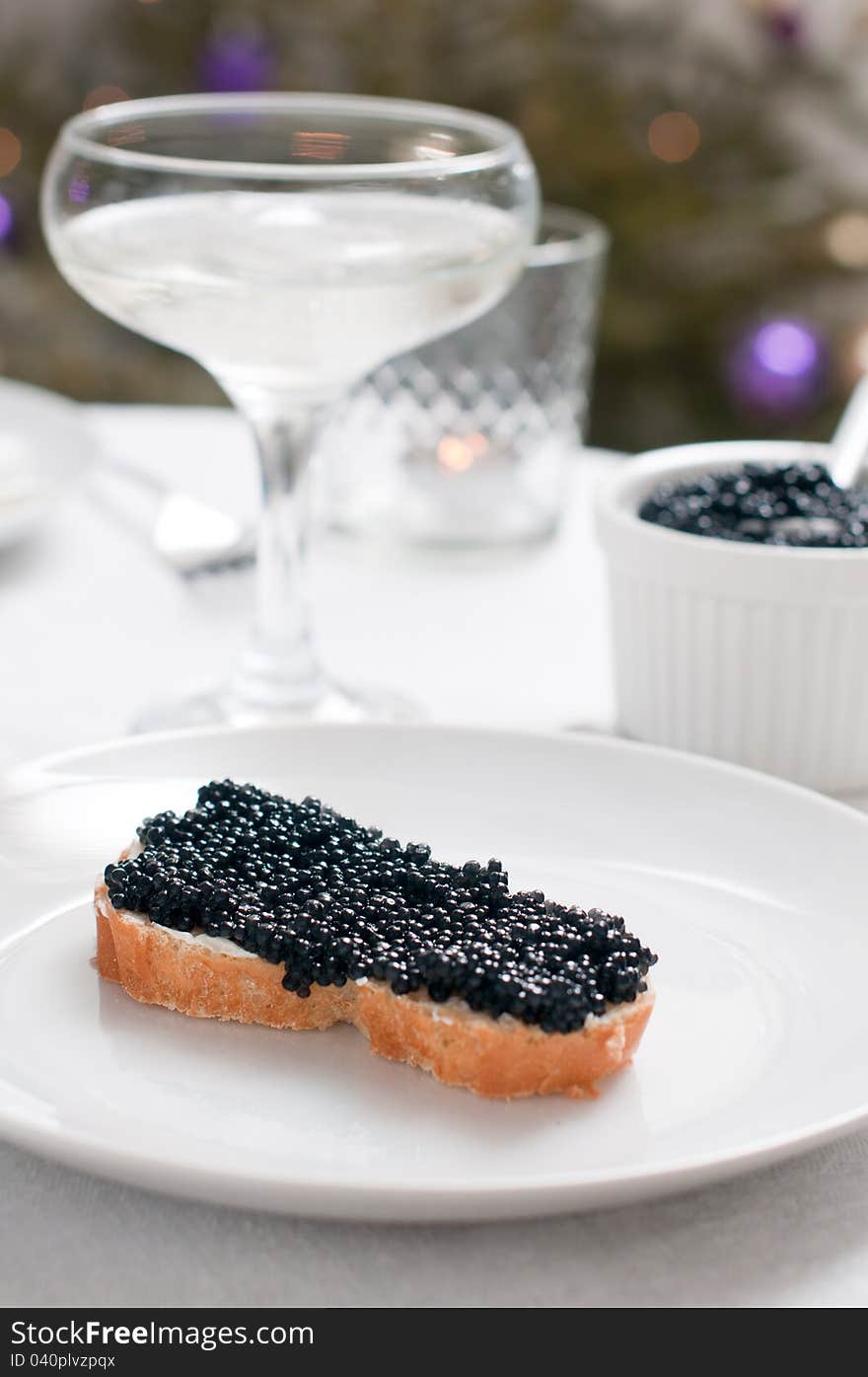 White bread with caviar on a ceramic plate